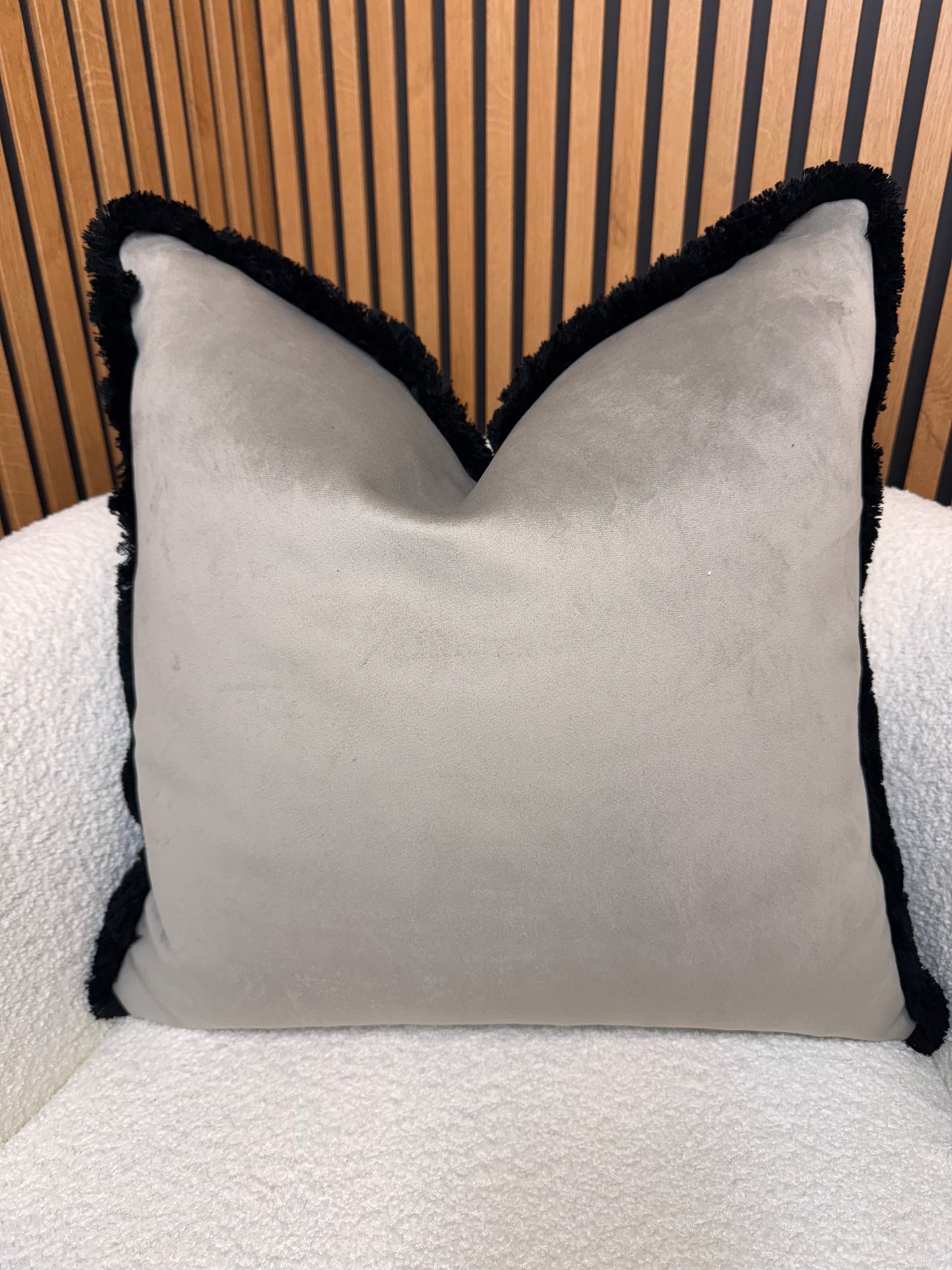 Pebble with black fringe cushion