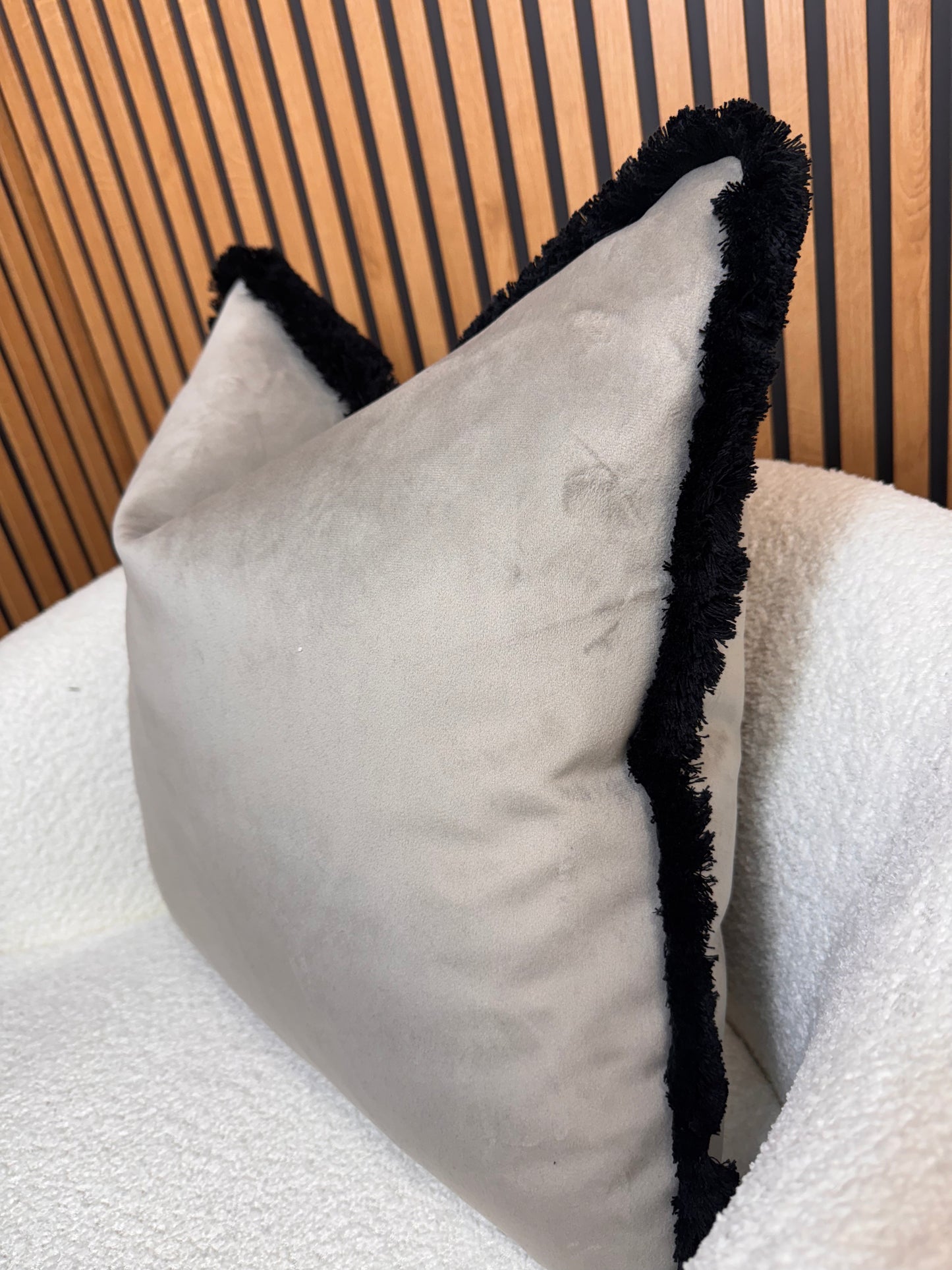 Pebble with black fringe cushion