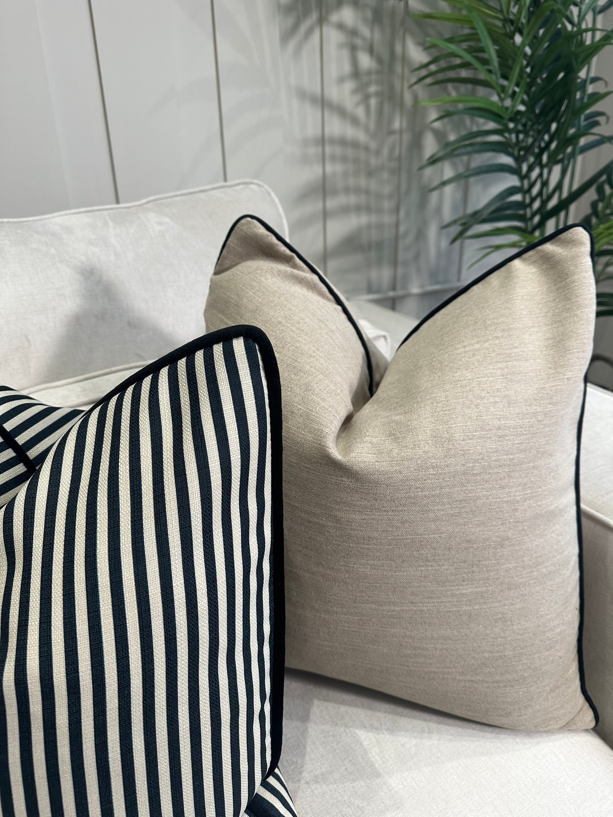 Beige linen like cushion with black piping
